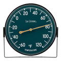 Head-on image of the 104-1512F 5-inch Dial Thermometer with Bracket features an emerald green dial with white temperature readings in a Fahrenheit scale from -60 to 120 degrees, with an antique gold pointer shown with the mounting bracket/stand positioned at the bottom