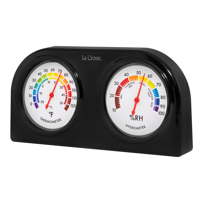 Left-facing image of the 104-288 Indoor Temperature and Humidity Gauge. Featuring dual dials with a rainbow scale, the temperature dial is on the left, reading 0-120 degrees Fahrenheit and -20-50 degrees Celsius, and the humidity dial is on the right, reading 10-100 percent RH with comfort level text.