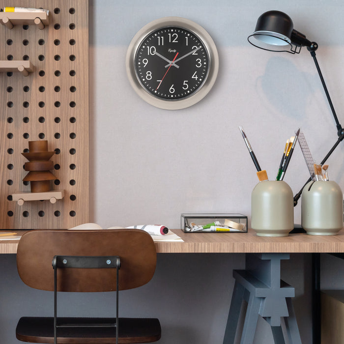 Modern office setup with a clock on the wall, desk, chair, and lamp.