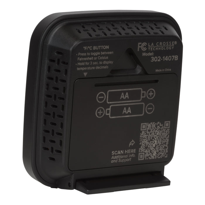 Back angled image of the 302-1407B Thermometer with Temperature and Humidity - Black. The image shows the hanging keyhole and the battery compartment with the fold down stand in use, there is a QR code for support and additional text to provide direction.