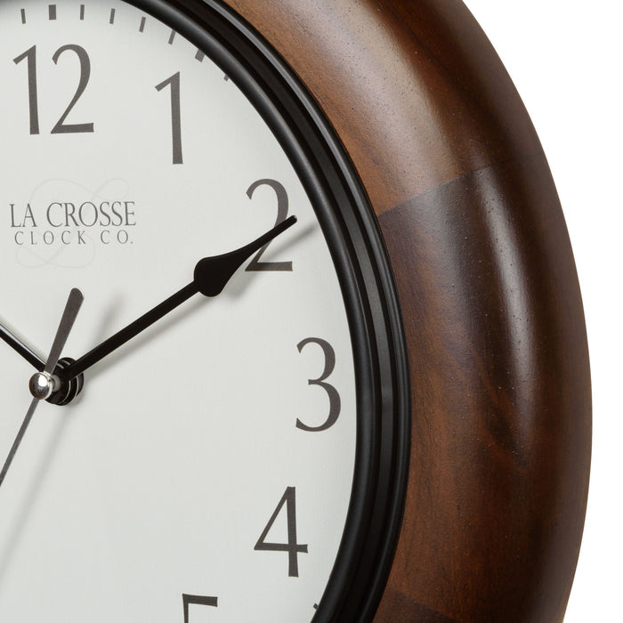 Closeup of the dark wood stained frame and white dial of the 404-2625 Linwood 10-inch wall clock