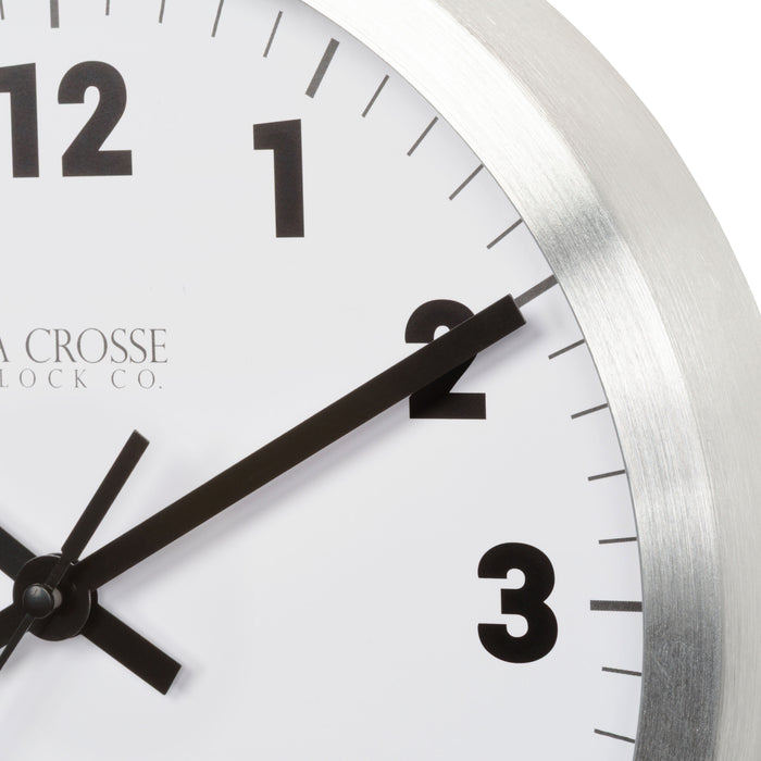 Close up image of the dial and frame for the 404-2626 10-inch Nash Wall Clock with silver finish metal frame, black numbers, black metal hands: hour, minute, second, and a white dial