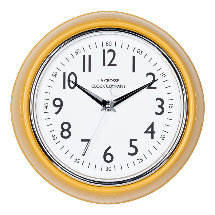 Head-on image of the 404-3024MY 9.5-inch Diner Clock – Mustard Yellow. The clock features a retro-style mustard yellow frame with a white dial, chrome bezel, black numbers and minute markings, black metal hands, and a silver second hand.