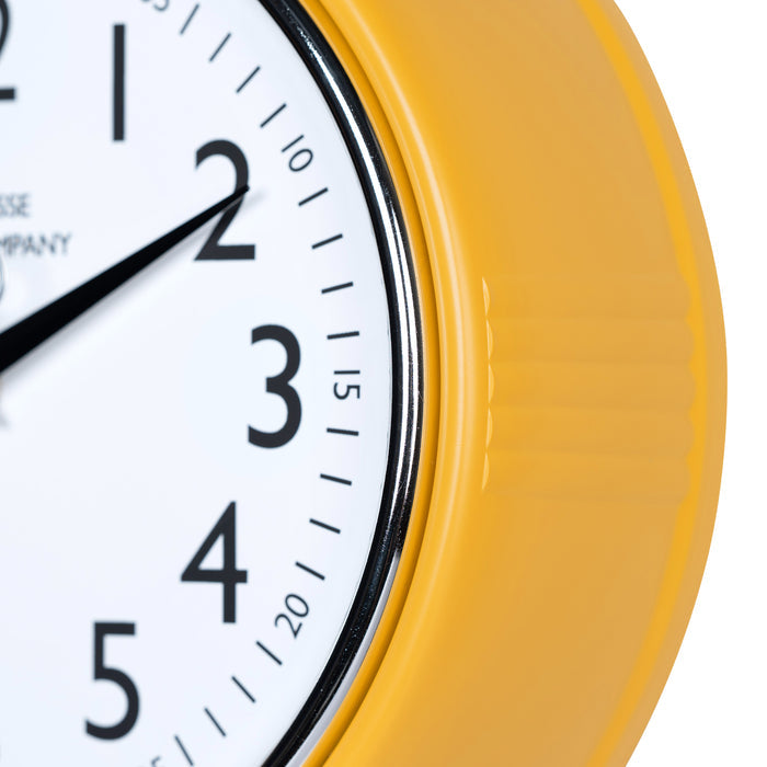 Close-up frame image of the 404-3024MY 9.5-inch Diner Clock – Mustard Yellow, features a retro-style mustard yellow frame with a white dial, chrome bezel, black numbers and minute markings, black metal hour and minute hands, and a silver second hand.