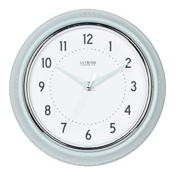 Head-on image of the 404-3024PH 9.5-inch Diner Wall Clock - Pistachio. The clock features an off-white dial with black numbers, pistachio hour dots, pistachio hour and minute hands, and a silver accent second hand set within a vintage-retro pistachio green frame.