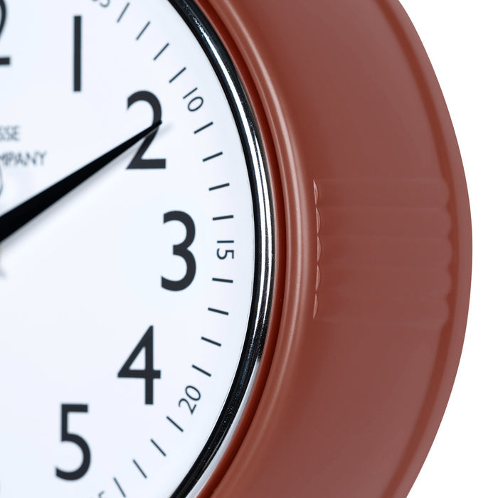 Close-up frame image of the 404-3024TC 9.5-inch Diner Clock – Terracotta features a retro-style terracotta frame with a white dial, chrome bezel, black numbers and minute markings, black metal hands, and a silver second hand.