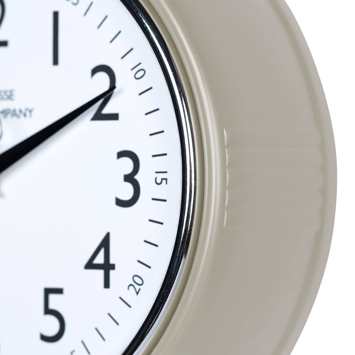 Close-up frame image of the 404-3024TP 9.5-inch Diner Clock – Taupe, features a retro-style taupe frame with a white dial, chrome bezel, black numbers and minute markings, black metal hands, and a silver second hand.