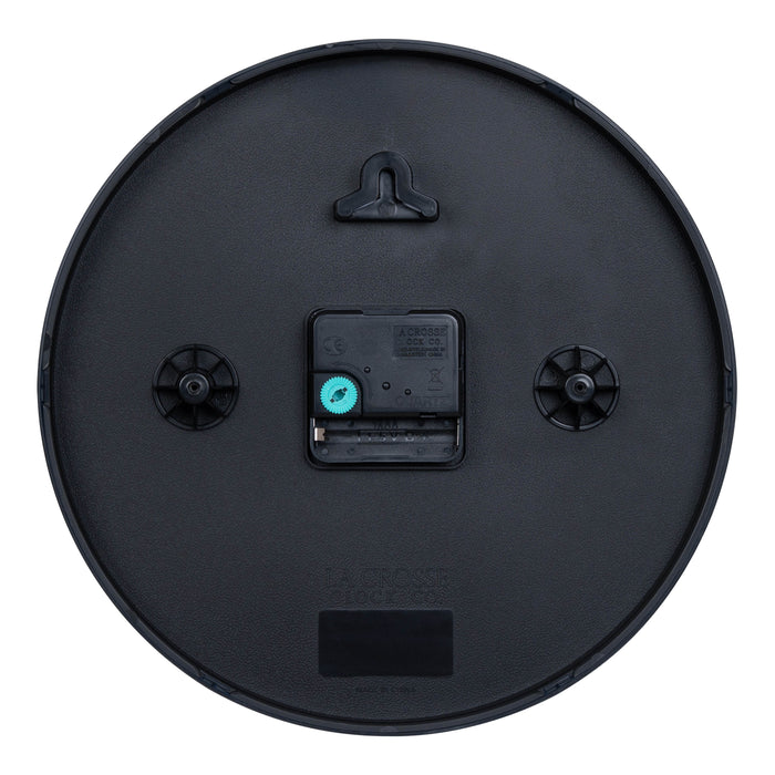 Back image of the 404-3025 10-inch Basic Decor Wall Clock showing the hanging hole for mounting, easy set teal time wheel, the La Crosse Clock Quartz movement with battery compartment