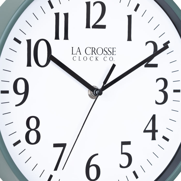 Close-up image of the dial of the 404-3025G 10-inch Basic Decor Wall Clock with a Green frame, white dial with black numbers, hour, and minute hands, and a black second hand