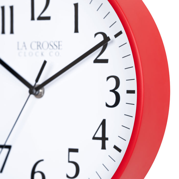 Close-up image of the Red frame of the 404-3025R 10-inch Basic Decor Wall Clock with a white dial, black numbers, hour, minute, and second hands.