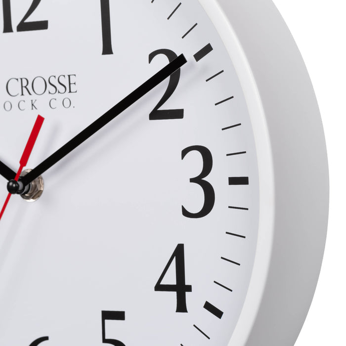 Close-up image of the White frame of the 404-3025W 10-inch Basic Decor Wall Clock with a white dial, black numbers, hour, minute hands, and a red second hand