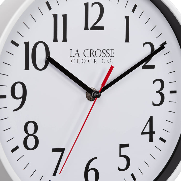 Close-up image of the dial of the 404-3025W 10-inch Basic Decor Wall Clock with a White frame, white dial with black numbers, hour, and minute hands, and a red second hand