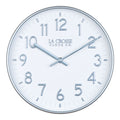 Head on view of view of the 404-3027B Tovi modern wall clock showing a white dial with silver Arabic numbers and a flush mount silver case  and matching silver hour and minute hands