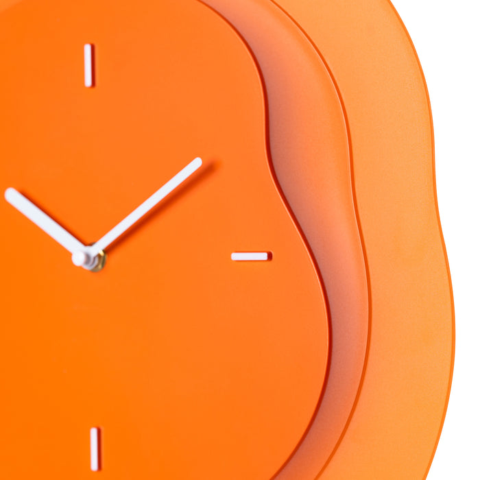 Close-up frame image of the 404-3039O 15.2-inch Drift Wall Clock – Orange featuring the open face multi-layered design with drifting contours, metal hands, and raised number markings in a brass finish.