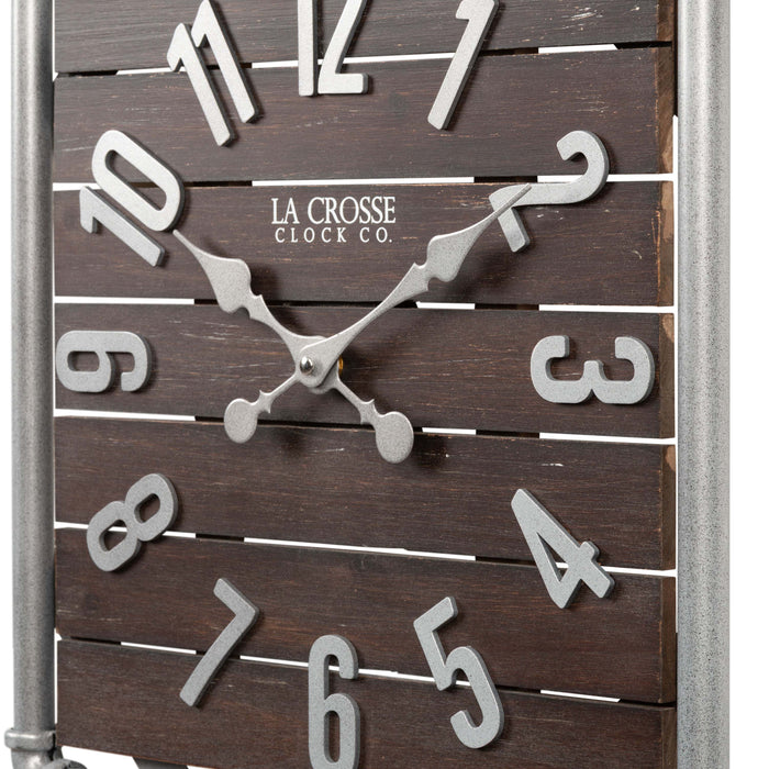 Close-up frame image of the 404-3412L 16-inch Foundry Metal & Wood Wall Clock - Light. The clock features a square metal pipe frame, stained wood slats, and metal pewter finish accents.
