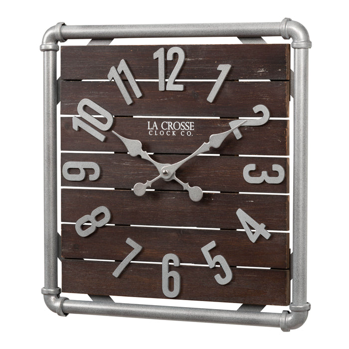 Left-facing image of the 404-3412L 16-inch Foundry Metal & Wood Wall Clock - Light. The clock features a square metal pipe frame in a weathered pewter finish, a truffle-brown-stained wood slat clock face with pewter-finished metal numbers and hands.