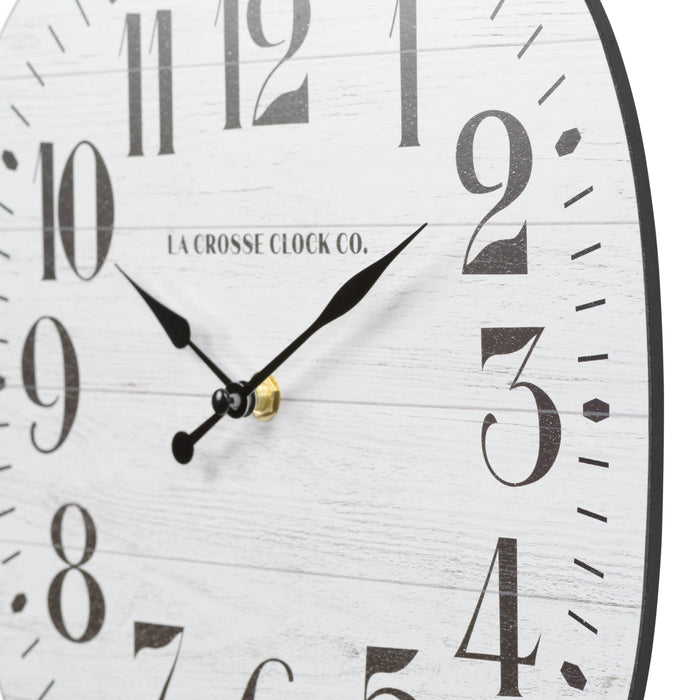 Dial close up of the 404-3428 11-inch Sylvie square MDF open face wall clock featuring a faux whitewash wood dial black numbers and metal hands