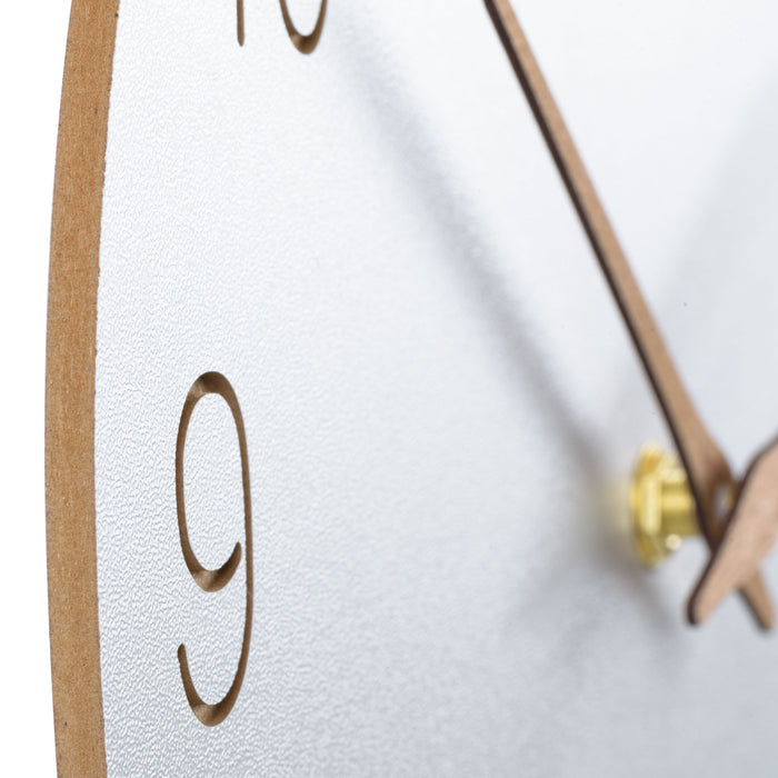 Close-up image of the edge of the MDF and vinyl construction of the  404-3630B 12-inch Sierra Wood Wall Clock – White, featuring laser-cut numbers and wood hour and minute hands.
