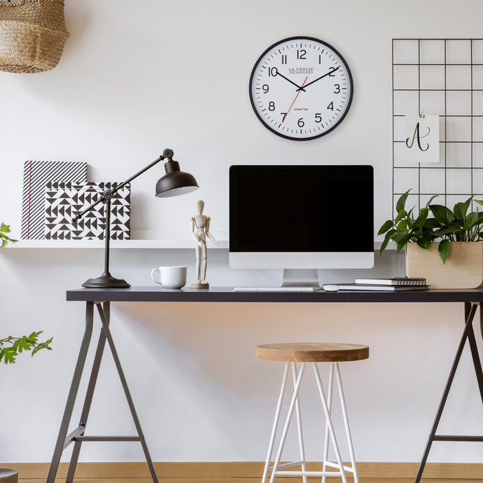 404-3730 Modern home office with a desk, computer monitor, lamp, and clock on the wall.