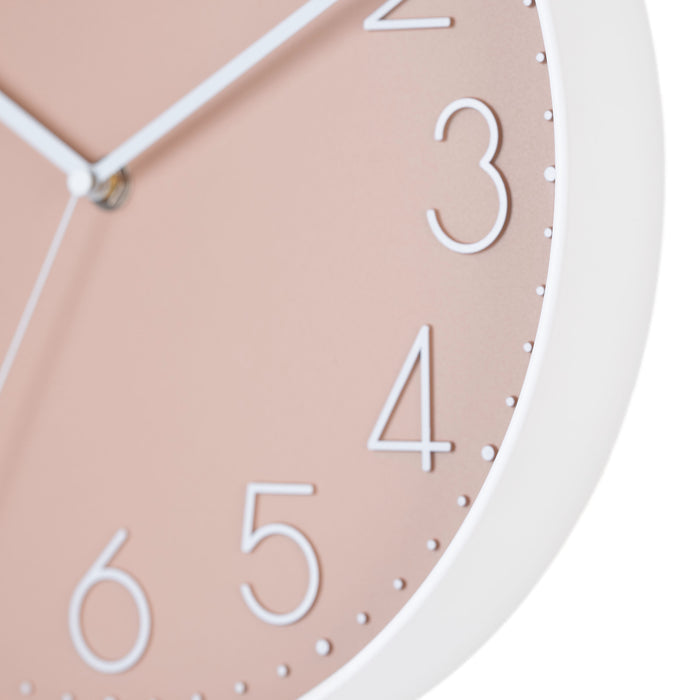 Close-up image highlighting the frame of the 404-3831P 12-inch Paxton Wall Clock - Peach, with Silent Sweep, featuring a flush-mount peach frame, a matching color dial, white raised numbers, and white metal hour, minute, and second hands.