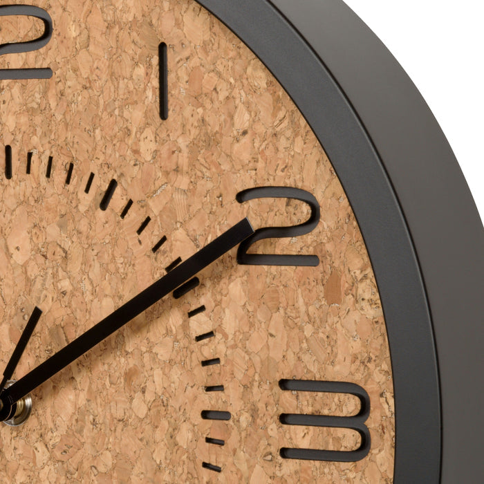 Close-up image of the frame and dial of the 404-3832 Felix Cork 12-inch Wall Clock featuring a dark flush mount case, a cork dial, laser cut numbers, and black metal hands with silent sweep movement