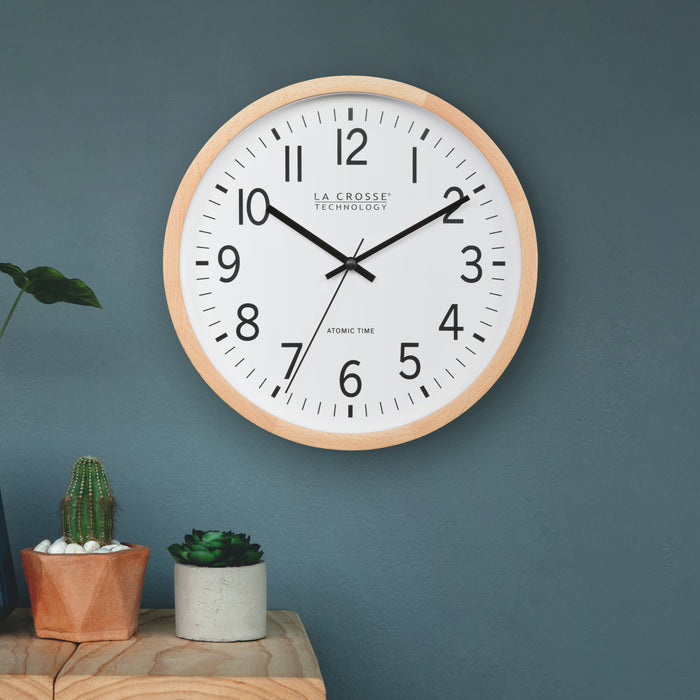 Wall clock with wooden frame on a blue wall, featuring 'La Crosse Technology' brand.
