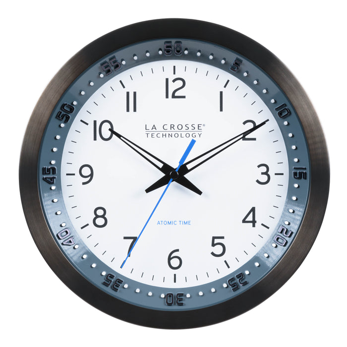 Head-on image of the 404-54667 10-inch Atomic Metal Wall Clock with Blue Chapter Ring. The clock features a black stainless steel frame with a blue chapter ring and raised seconds indicators, surrounding a white dial with black numbers, metal hands, and a blue accent second hand.