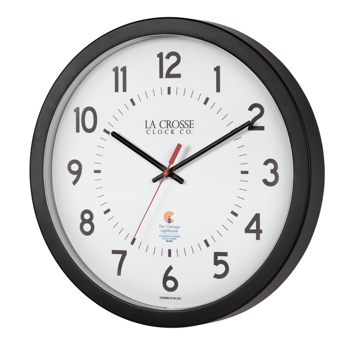 Left-facing image of the 404-5537 14.5-inch Wall Clock with black bold numbers, black hour and minute hands, and a red second hand. Two logos apear on the clock, 
La Crosse Clock Co. and Chicago Lighthouse industries - a partner that employs the blind to bring this classic wall clock to consumers.