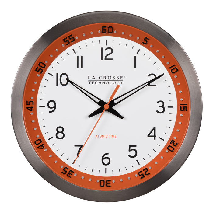 Head-on image of the 404-87696 10-inch Atomic Metal Wall Clock - Chapter Ring: Orange. The clock features a white dial, an orange chapter ring with seconds indicator, black hands, an orange second hand, and a stainless steel flush-mount frame.