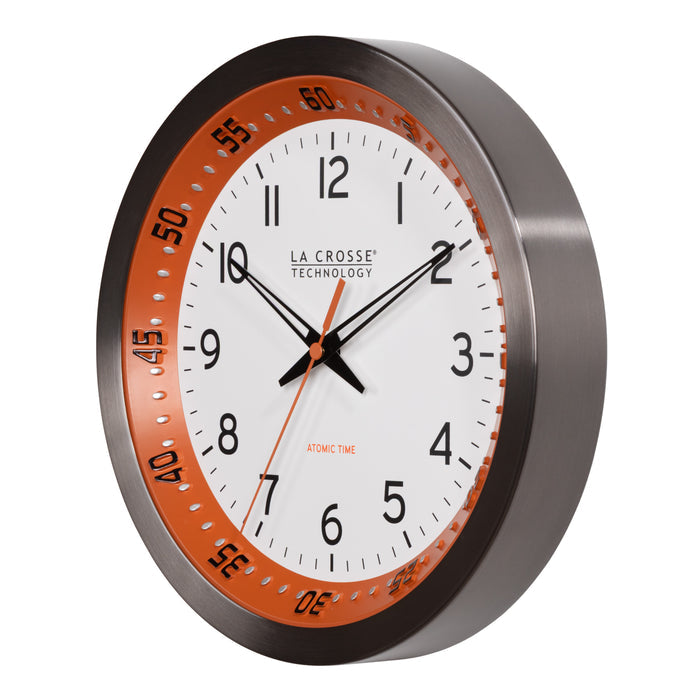 Left-facing image of the 404-87696 10-inch Atomic Metal Wall Clock - Chapter Ring: Orange. The clock features a white dial, an orange chapter ring with seconds indicator, black hands, an orange second hand, and a stainless steel flush-mount frame.