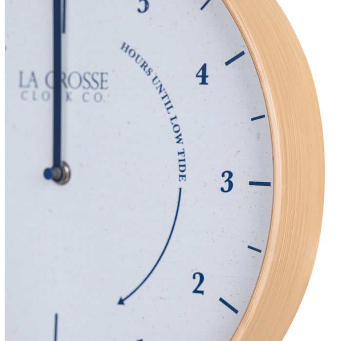 Close-up image of the natural wood frame detail of the 425-3831 11.8-inch Tide Wall Clock. The clock features a light wood frame, a white and tan speckled dial, blue numbers, markings, and a blue metal hand.