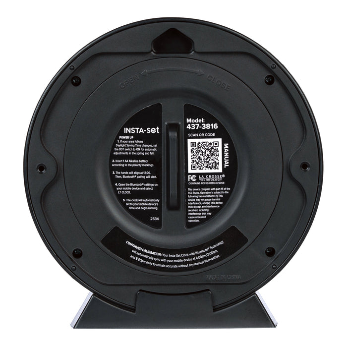 Head-on back image of the 437-3816 Insta-Set Table/Wall Clock with Bluetooth® Technology showing  the back of the clock with the battery cover on and the instructions printed on the back with a support QR code.