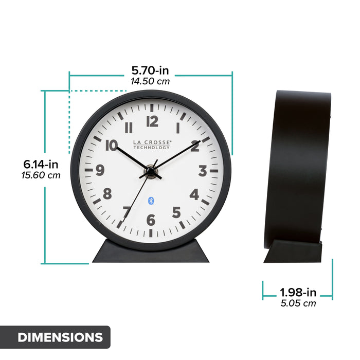 Dimension image in inches and centimeters for the  437-3816 Insta-Set Table/Wall Clock with Bluetooth® Technology featuring a white dial with bold black numerals, black metal hands, and a black frame with removable base for tabletop or wall hanging placement. The clock measures 5.70 in L x 1.98 in W x 6.14 in H.