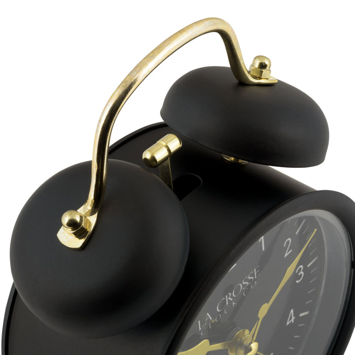 Detail shot of the twin bells of the 617-3314BG Metal Twin Bell Alarm Clock – Black, the clock features a black dial with white numbers, gold hands and accents, in a black metal case.