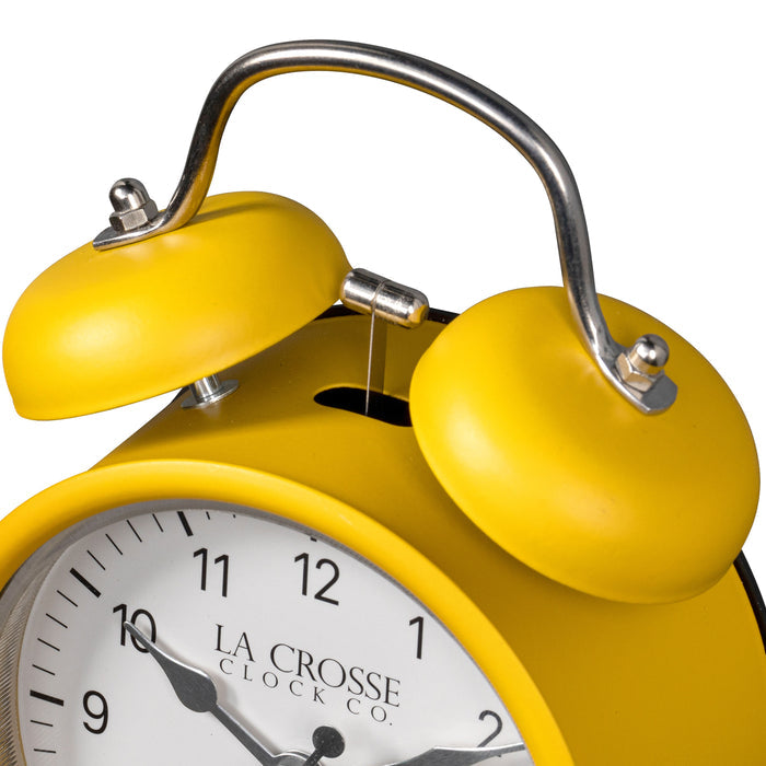 Close-up detail image of the 617-3314MY Metal Twin Bell Alarm Clock – Mustard Yellow, showing the twin bell and hammer of the alarm clock. The clock features a White dial with black numbers, silver hands and accents, in a mustard yellow metal case.