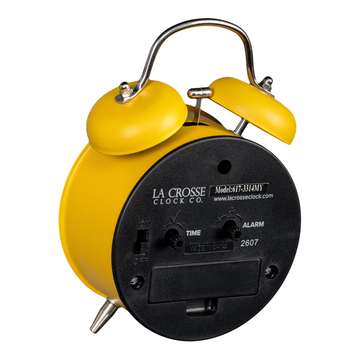 Angled back image of the 617-3314MY Metal Twin Bell Alarm Clock – Mustard Yellow, showing the battery compartment, knobs, and the on/off switch.