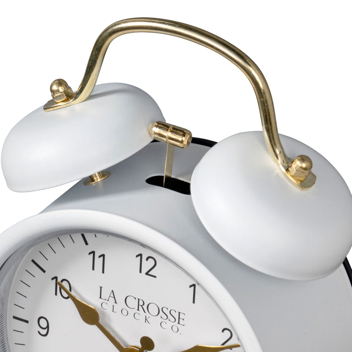 Detail shot of the twin bells of the 617-3314W Metal Twin Bell Alarm Clock – White, the clock features a white dial with black numbers, gold hands and accents, in a white metal case.