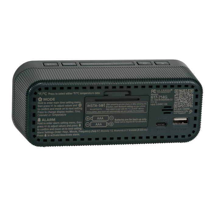 Angled back view of the 617-714G Insta-Set Digital LED Alarm Clock with Bluetooth® Technology - Green, showing the buttons, the battery compartment, the USB-C power port, the USB-A charging port, and the operating instructions.