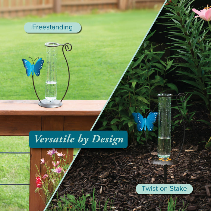 704-71077 Glass rain gauge with butterfly design on a stand and stake, outdoors.
