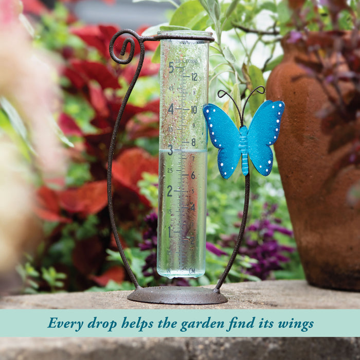 704-71077 Rain gauge with a blue butterfly decoration in a garden setting